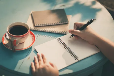 "Open journal with pen, symbolizing the practice of morning journaling."