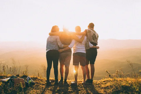 "Friends or family members talking or hugging, symbolizing social connection with loved ones."