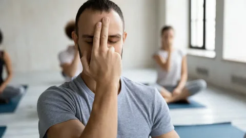 "Person practicing mindful breathing with a calm and peaceful expression."